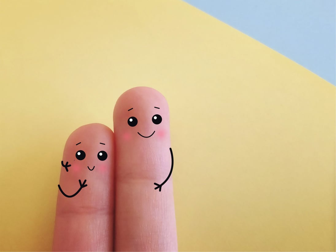 Two fingers decorated as two person. They are good friends.